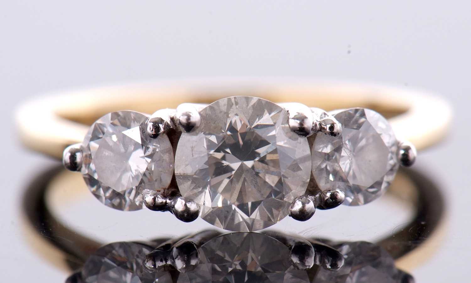 An 18ct three stone diamond ring, the three slightly graudated round brilliant cut diamonds, total - Image 3 of 11