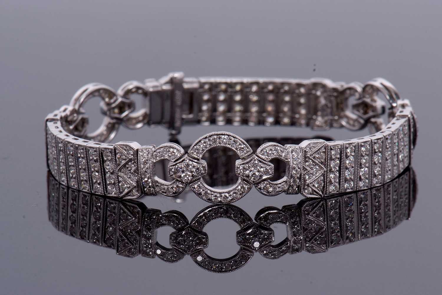 An 18ct white gold and diamond Art Deco style bracelet, comprised of three circlets of small round - Image 2 of 14
