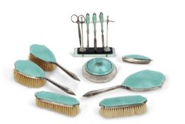 An Art Deco silver and guilloche enamel vanity set, each with a turquoise enamel decoration