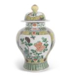 A 19th Century Chinese porcelain famille vert jar and cover, with central panels of flowers on a