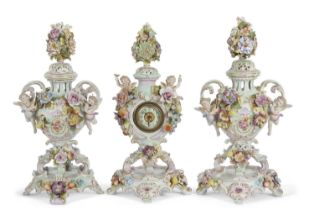 A garniture of late 19th Century continental porcelain pot pourri vases with applied floral and