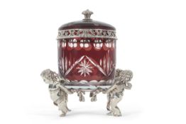 A figural putti silver plated bon bonniere, the flash cut ruby glass barrel with pull off domed