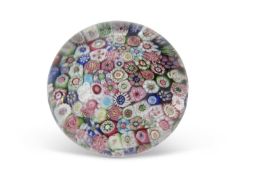 A Clichy Millefiori paperweight, the base with a blue and white striped design