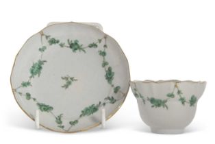 A Bristol porcelain tea bowl and saucer, the tea bowl of Ogee shape with a shaped saucer and gilt