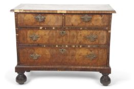 An early 18th Century and later walnut four drawer chest with two short and two long drawers