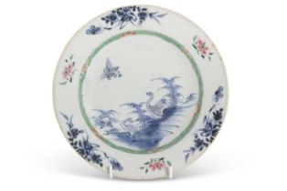 An 18th Century Chinese porcelain plate decorated in Kangxi style with a blue and white design of