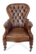 A Victorian buttoned brown leather upholstered armchair, the arms with scroll end decoration and