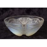 A 1930's Lalique bowl in the Coquilles pattern with shell moulded opalescent feet, 21cm diameter,