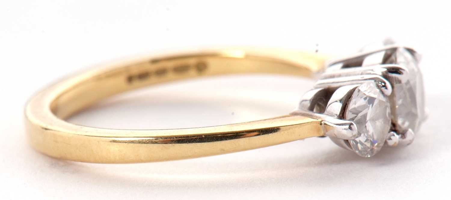An 18ct three stone diamond ring, the three slightly graudated round brilliant cut diamonds, total - Image 9 of 11