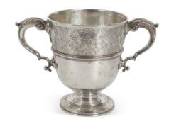 A George II bell-shaped two handled cup, chased above the girdle with scrolling foliage, enclosing