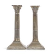 A pair of late Victorian silver candlesticks having Corinthian columns, classically decorated with