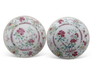 A pair of mid 18th Century Chinese porcelain famille rose plates decorated with floral sprays,