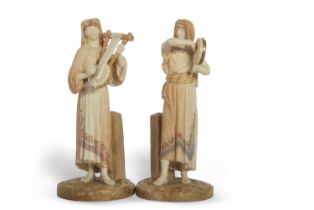 A pair of Royal Worcester Hadley figures of musicians on circular bases, factory mark and shape 1084