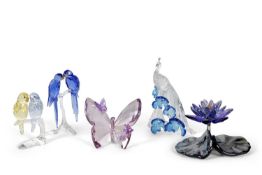 A group of Swarovski coloured models of a pair of blue maccaws on stand, a pair of budgerigars on