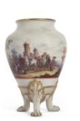 A continental porcelain vase raised on three paw feet with an armorial and painted scene of