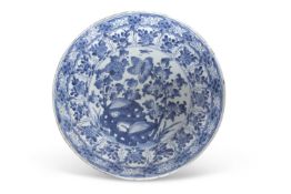 A large Chinese porcelain charger Kangxi period decorated in blue, the centre with floral sprays and