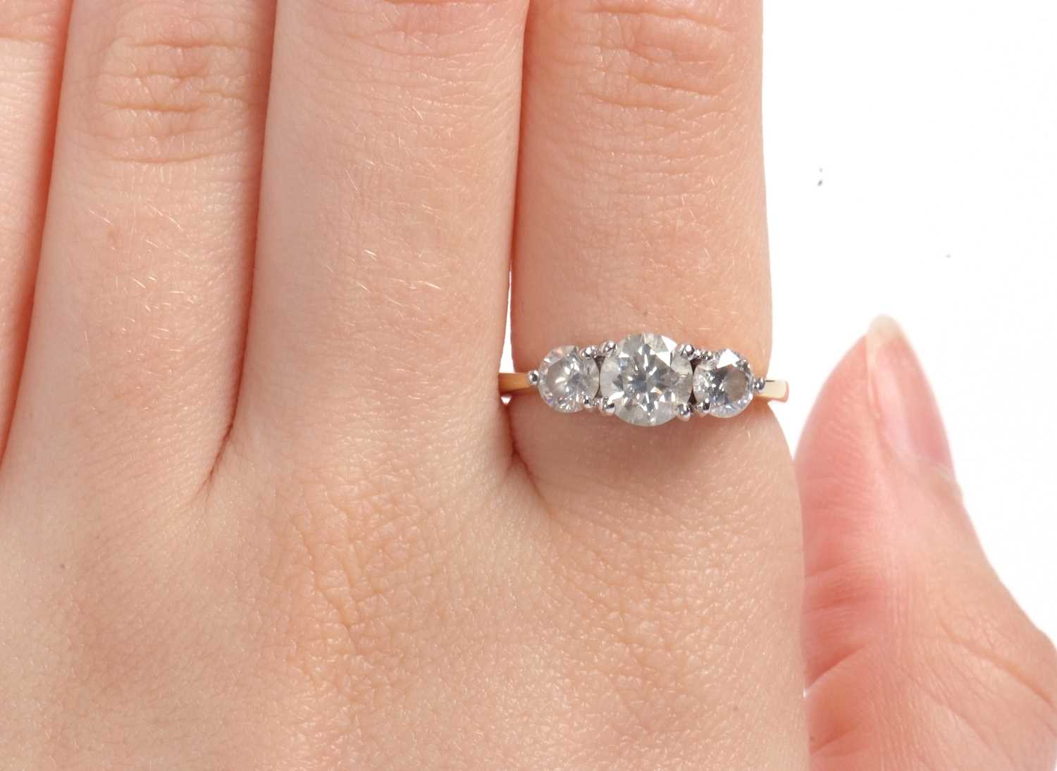 An 18ct three stone diamond ring, the three slightly graudated round brilliant cut diamonds, total - Image 11 of 11