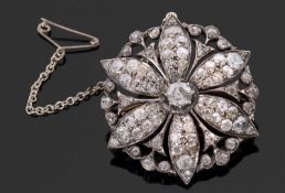 A late 19th / early 20th century diamond set flower brooch, the central round old mine cut diamond