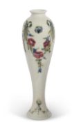 An early 20th Century Moorcroft vase, the slender baluster body decorated with swags of floral