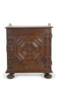 A small 17th Century and later mural cupboard with single door with moulded geometric decoration,