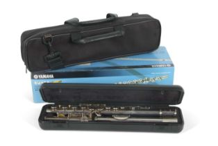 A Yamaha 311 flute in original fitted case and packaging the white metal body marked 311 with serial