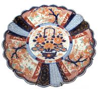 A Japanese porcelain charger decorated with scalloped edge in Imari fashion, Meiji period Wired