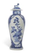 A 19th Century Chinese porcelain vase and cover, the blue ground decorated with prunus and panels of