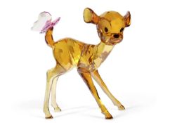 A Swarovski Disney model of Bambi in yellow with purple butterfly tail with original box