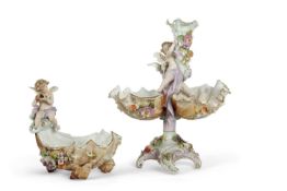 A late 19th Century continental porcelain shell moulded centre piece, the stem with two putti and