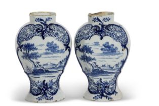 A pair of 18th Century Dutch Delft vases, both painted with a pastoral scene, 23cm high