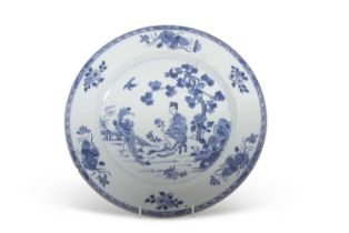 A Chinese porcelain large plate decorated in blue and white, Qianlong period, the centre painted