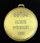 A commemorative gold award medal to 66704 Colchester Power Signalbox