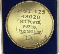 A commemorative gold award medallion to HST 125 43020 MTU Power Partnership