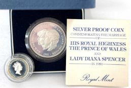 A pair of cased coins to include:A 1981 Silver proof coin to commemorate the marriage of HRH The
