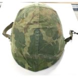 Mid 20th Century American Vietnam era military M1 helmet with liner and reversable oak camoflauge