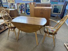 Ercol light elm drop leaf dining table together with two stick back carver chairs