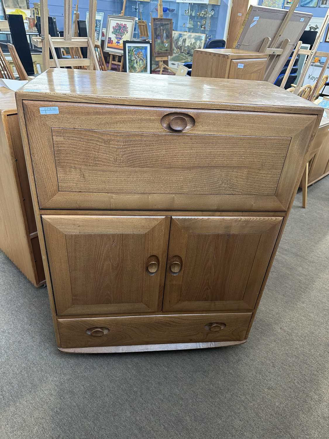 Ercol light elm bureau cabinet with drop down front over a drawer and cupboard base