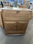 Ercol light elm bureau cabinet with drop down front over a drawer and cupboard base