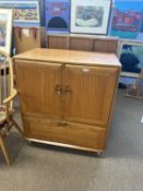 Ercol light elm television cabinet with two doors and drop down front, later internal