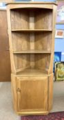 An Ercol light elm corner cabinet, 180cm high