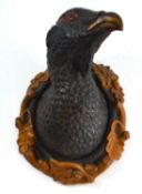 Painted pottery wall mounted bust of a Capercaillie with glass eyes, gold painted ochre leaf and