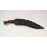 Good quality 20th Century military kukri with turned wooden handle and metal pommel with leather