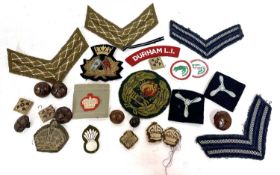 Quantity of 20th century cloth British military insignia to include chevrons, officers pips and