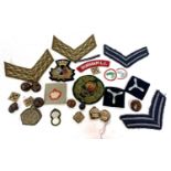 Quantity of 20th century cloth British military insignia to include chevrons, officers pips and