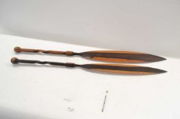 Pair of carved African ceremonial mango wood spears with twisted wooden handles and turned