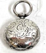 Hallmarked silver sovereign case of circular form, engraved all over with a foliate design (unable