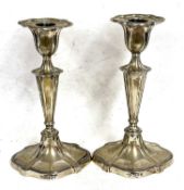 Pair of Edwardian silver candlesticks, plain oval form with reeded edges, oval tapering stems to
