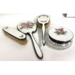 Group of four pieces of enamelled back dressing table wares to include hand mirror, hairbrush and