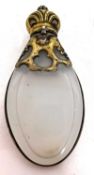An antique scent bottle, the oval flattened pear shaped body with a gilt metal frame, shoulder and