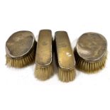 Four Edwardian silver backed hair/clothes brushes, each engraved with an armorial and hallmarked for